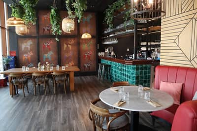 Elegant dining area with wooden tables at Ella's Eatery Restaurant Dubai, UAE