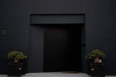 Modern entrance with potted plants at Bocasu Dubai, Dubai, UAE