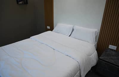 Cozy bedroom with white bedding at Royal Rave Yacht, Dubai, UAE