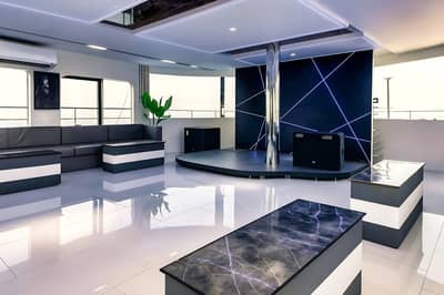 Modern interior with stage and seating at Royal Rave Yacht, Dubai, UAE.