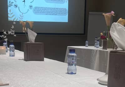 Conference table setup with flowers and water bottles at Sukani Royal Hotel Hail.