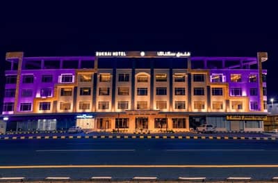 Illuminated exterior of Sukani Royal Hotel Hail, Hail, Saudi Arabia at night.