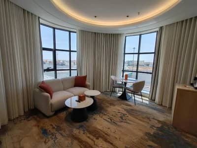 Elegant guest room with seating area at Ayas Hotel Hail, Saudi Arabia