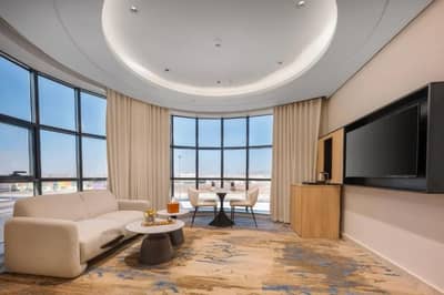 Elegant guest room with seating area at Ayas Hotel Hail, Saudi Arabia.