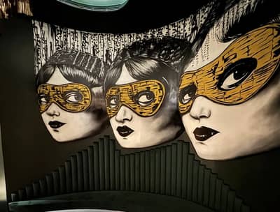 Artistic mural with masked faces at The Banc Dubai, Dubai, UAE