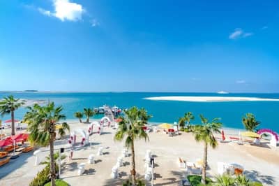 Beachfront venue with palm trees and ocean view at Voco Dubai Nice, Dubai, UAE