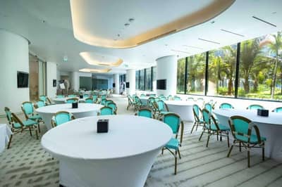 Spacious event room with round tables at Voco Dubai Nice, Dubai, UAE