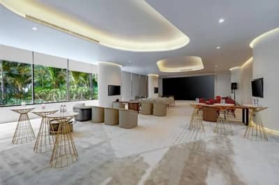 Spacious event room with seating and tables at Voco Dubai Nice, Dubai, UAE.