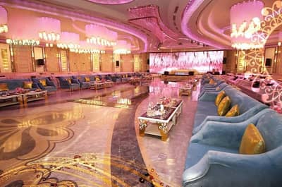 Luxurious event hall with chandeliers and seating at H Laylati Event Venue, Madinah.