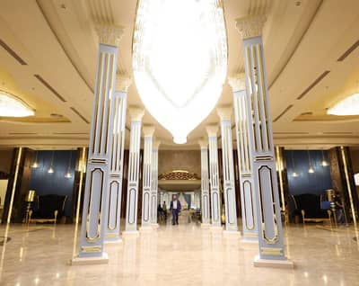 Elegant interior with columns and chandeliers at H Laylati Event Venue, Madinah.