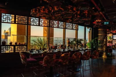 Elegant dining area with decorative windows at Asia Asia The Palm, Dubai, UAE.