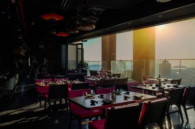 Elegant dining area with city view at Asia Asia The Palm, Dubai, UAE.