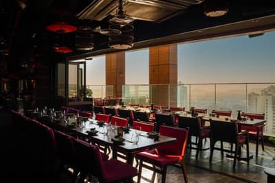 Elegant dining area with city view at Asia Asia The Palm, Dubai, UAE.
