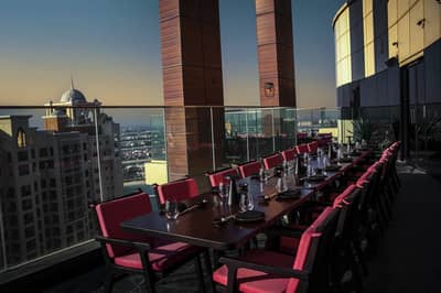 Outdoor dining setup with city view at Asia Asia The Palm, Dubai, UAE