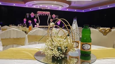 Elegant table setting with floral centerpiece at Sadeem Celebrations Hall Abha, Saudi Arabia.