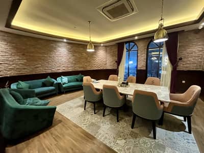 Elegant dining area with sofas and table at Soul Restaurant Al Bahah, Saudi Arabia.