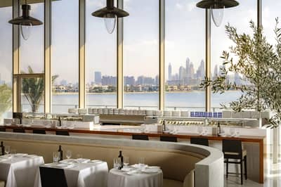 Elegant dining area with city skyline view at Estiatorio Milos Dubai, UAE.