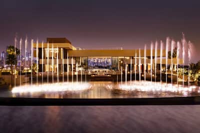 Illuminated fountains and modern architecture at Estiatorio Milos Dubai, Dubai, UAE