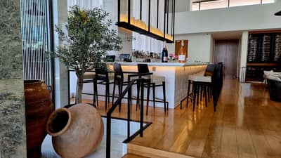 Elegant bar area with seating at Estiatorio Milos Dubai, Dubai, UAE
