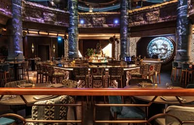 Elegant interior with central bar and decorative pillars at AMARU Dubai, UAE.