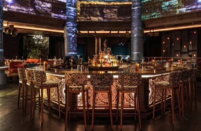 Elegant bar area with patterned stools at AMARU Dubai, Dubai, UAE