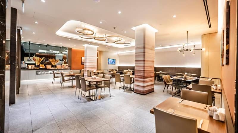 Lamartine Hotel - a restaurant with tables and chairs and a counter at Lamartine Hotel in Istanbul