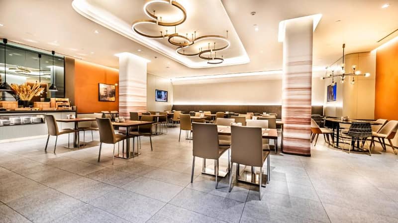 Lamartine Hotel - a dining room with tables and chairs in a restaurant at Lamartine Hotel in Istanbul