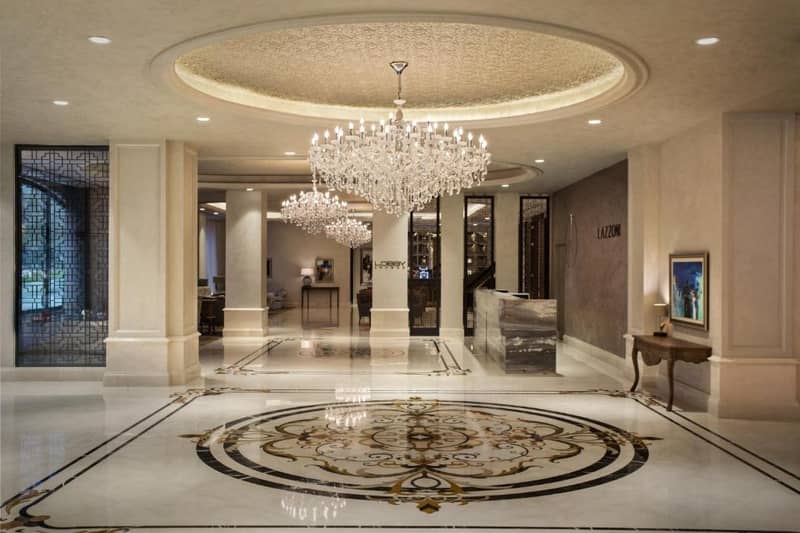 Lazzoni Hotel - a large lobby with a chandelier and a large rug at Lazzoni Hotel in Istanbul