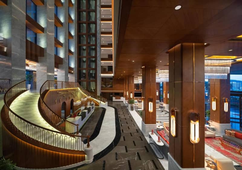 Mövenpick Hotel Istanbul Asia Airport - a lobby of a hotel with a spiral staircase at Mövenpick Hotel Istanbul Asia Airport in Istanbul