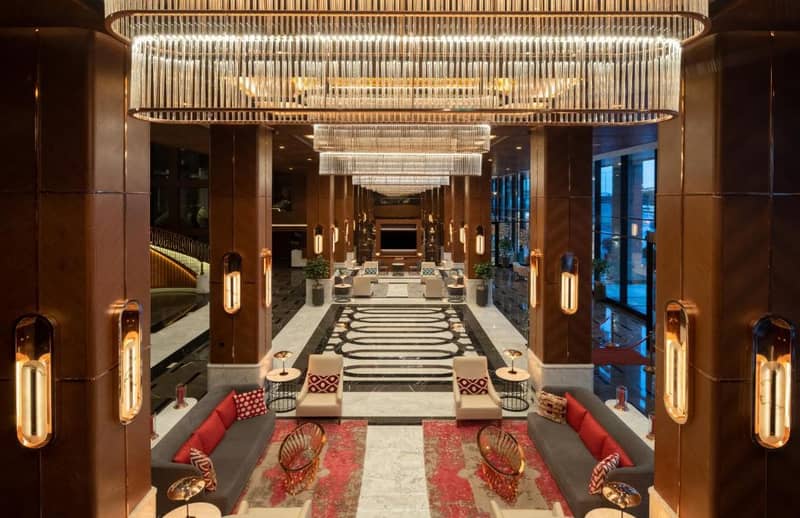 Mövenpick Hotel Istanbul Asia Airport - a view of a hotel lobby with a large chandelier at Mövenpick Hotel Istanbul Asia Airport in Istanbul