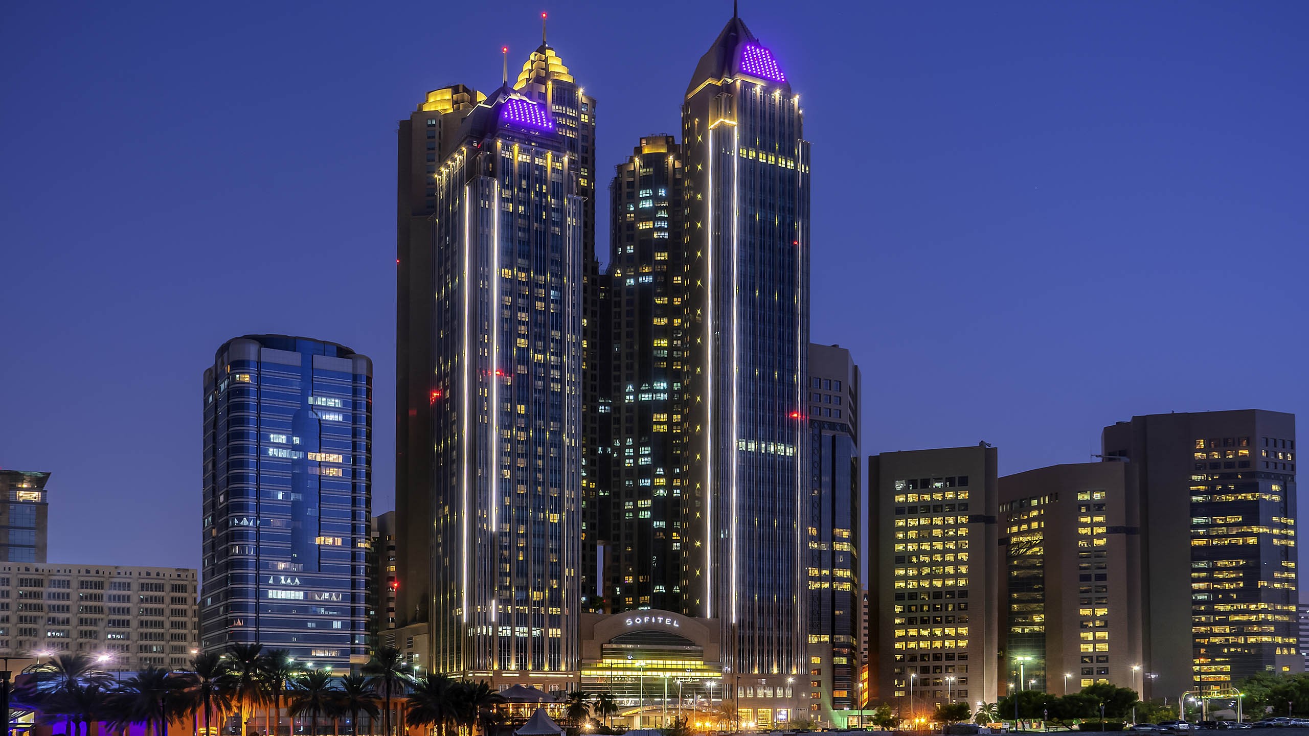 Sofitel Abu Dhabi Corniche illuminated at night, ideal for events.
