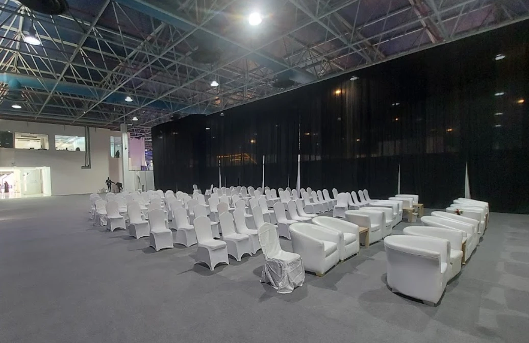 Jeddah International Exhibition Center with arranged white chairs and sofas.