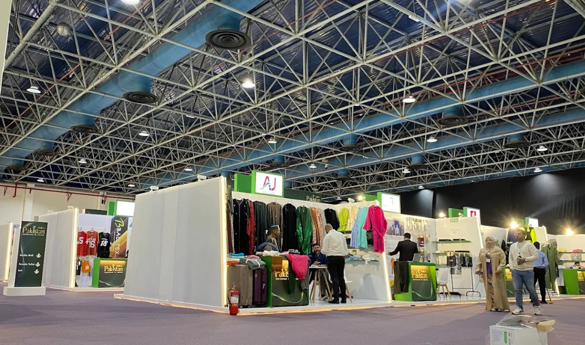 Jeddah International Exhibition Center with colorful fabric displays and visitors.