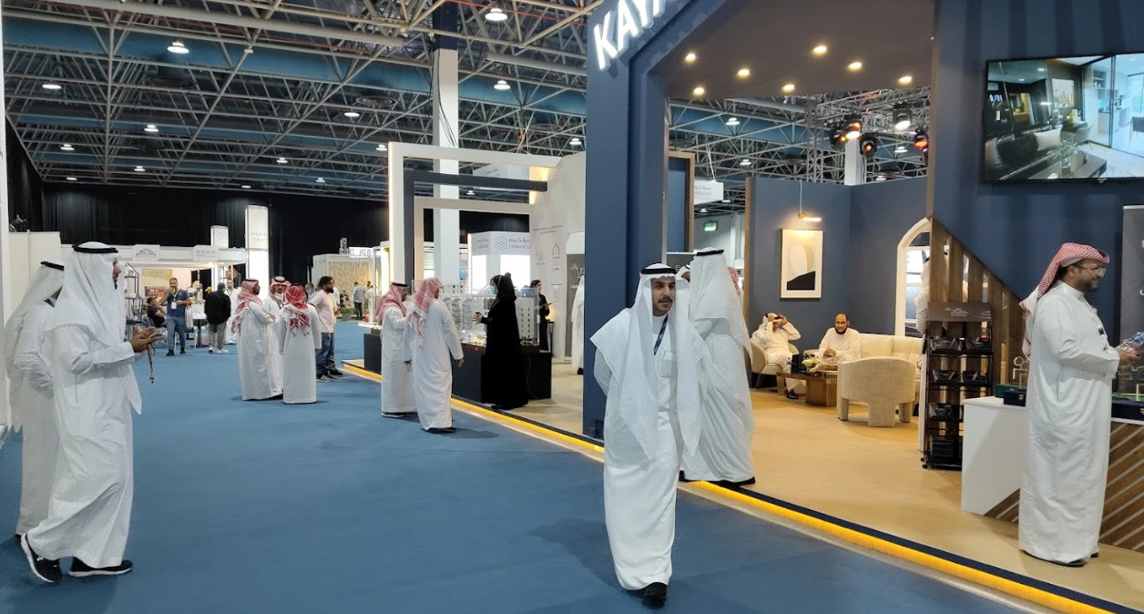 Jeddah International Exhibition Center bustling with visitors in traditional attire.