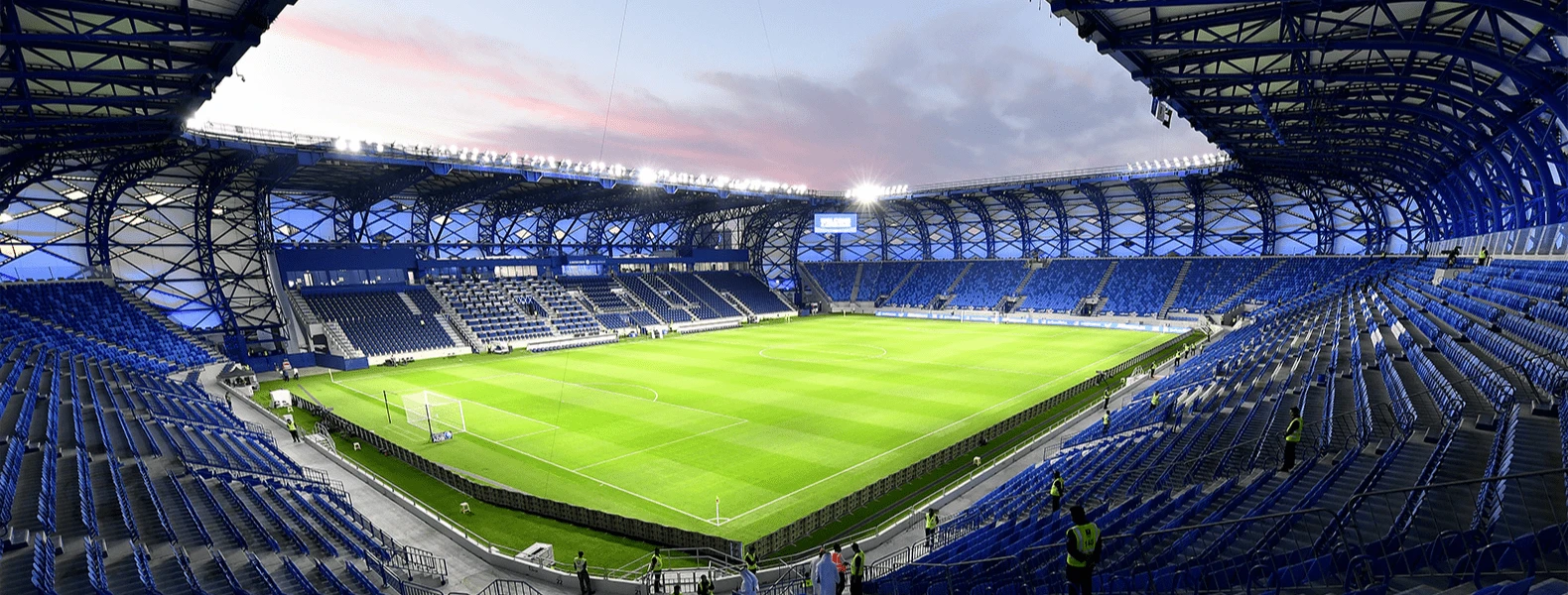 Al Nasr Al Maktoum Stadium in Dubai, empty with blue seats.